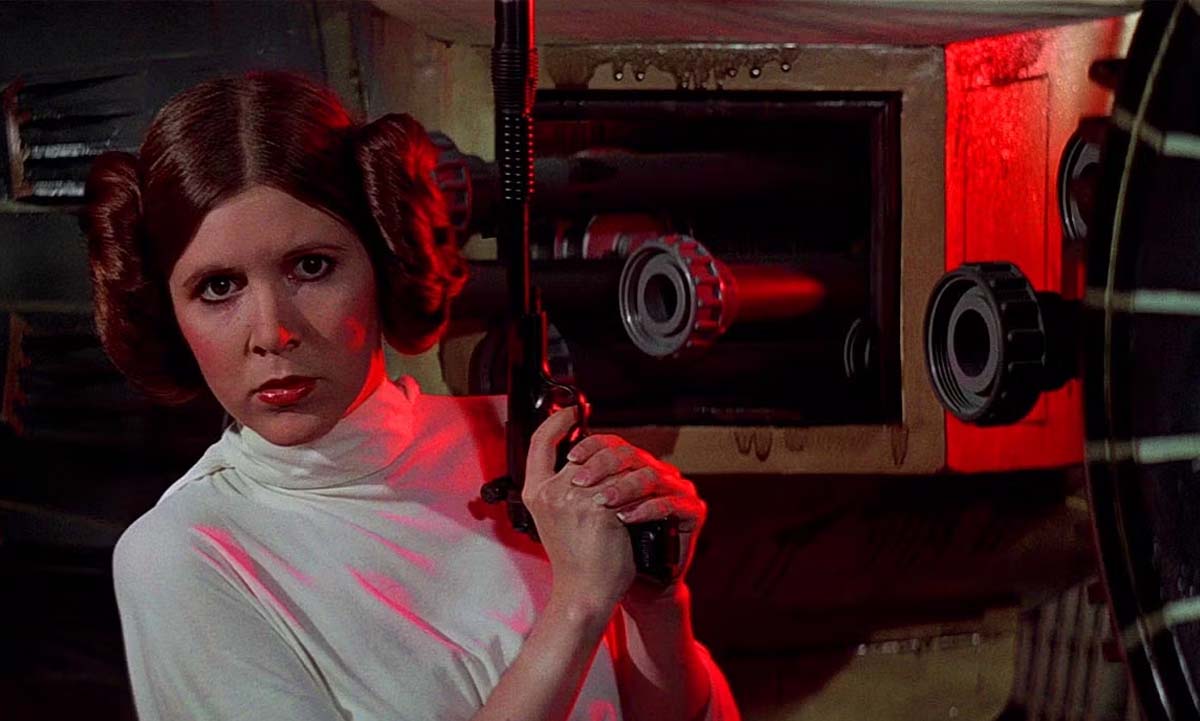 Princess Leia holds a blaster in Star Wars